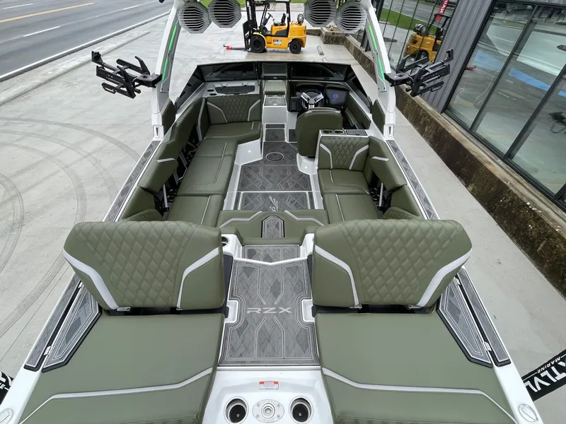 Slide: The Image of Interior view of 2024 Tigé 24RZX boat with green seating. - 14