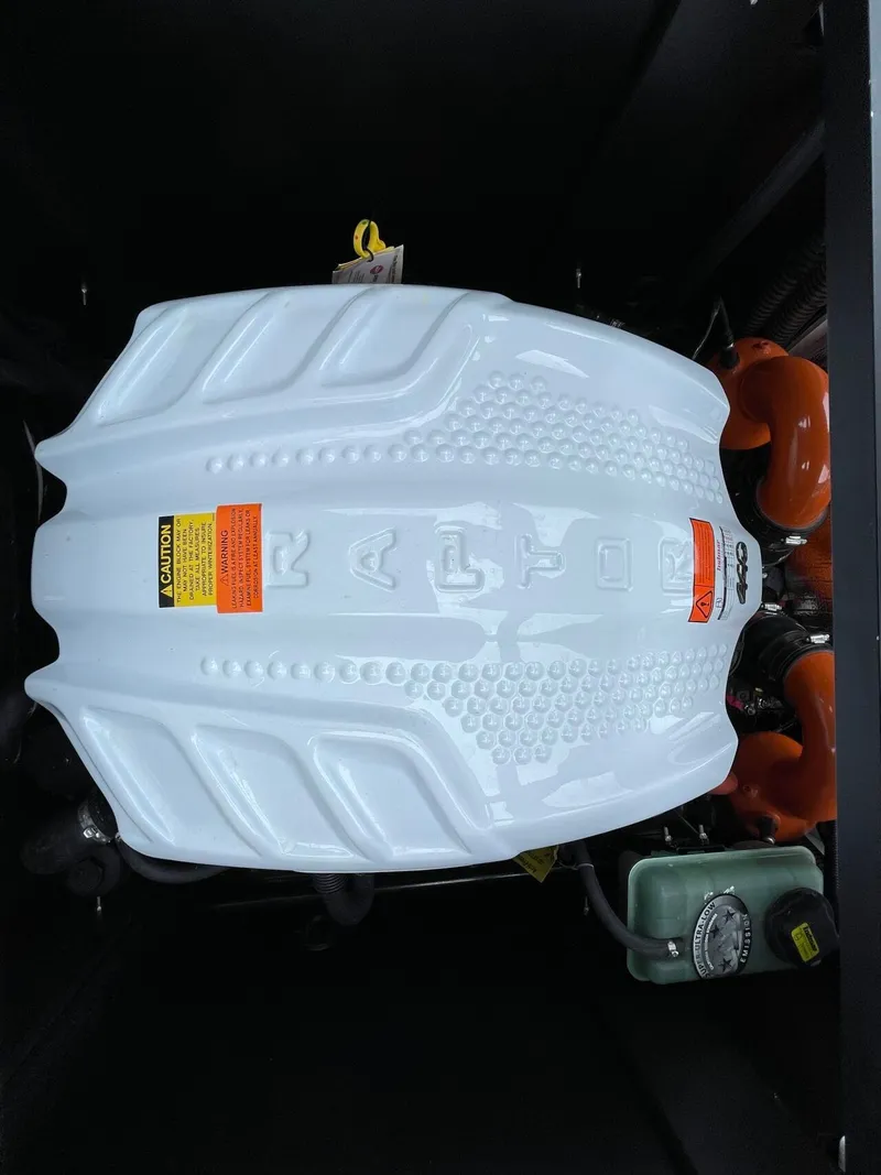 Slide: The Image of Engine cover of 2024 Tigé 24RZX boat, white with orange accents. - 16