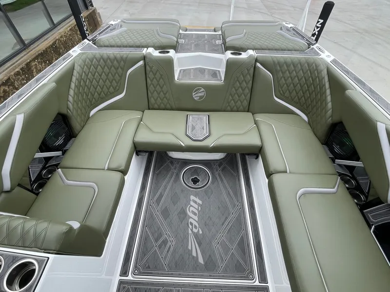 Slide: The Image of 2024 Tigé 24RZX interior with green upholstery and modern design. - 19