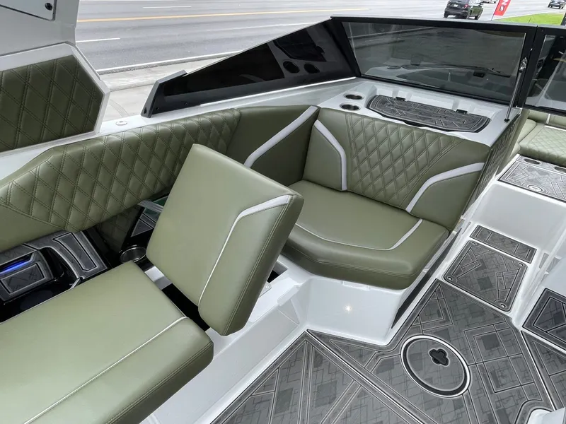 Slide: The Image of Interior of 2024 Tigé 24RZX with green leather seating. - 31