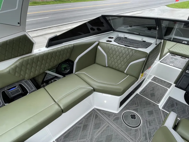 Slide: The Image of Interior of 2024 Tigé 24RZX with green leather seating. - 32