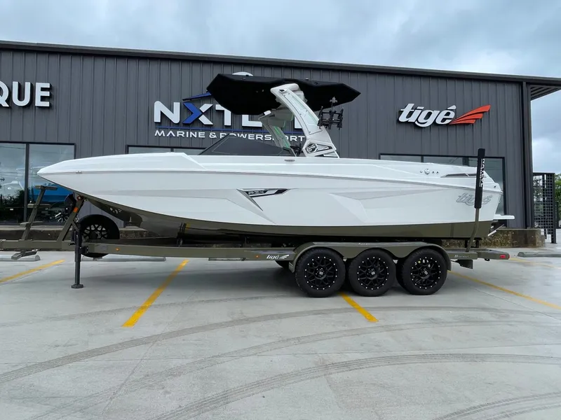 Slide: The Image of 2024 Tigé 24RZX boat on trailer in front of building. - 4