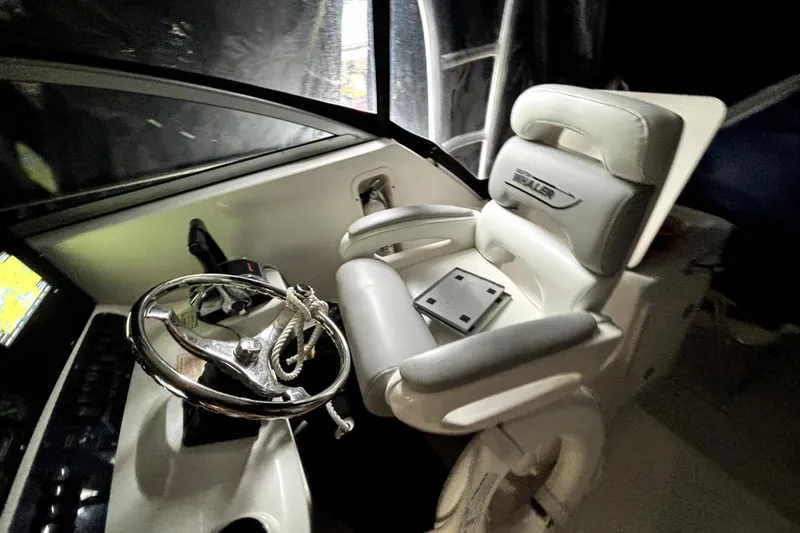 Slide: The Image of Helm of 2005 Boston Whaler 305 Conquest with steering wheel and captain's chair. - 10