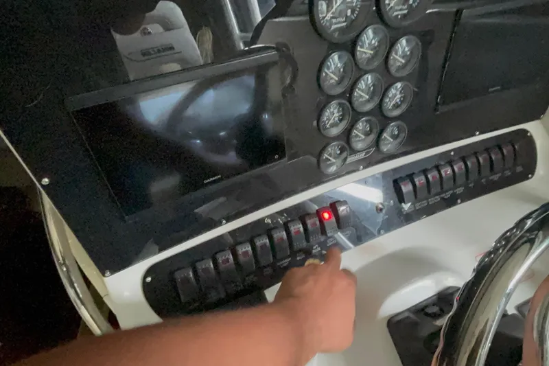 Slide: The Image of Dashboard of a 2005 Boston Whaler 305 Conquest with gauges and control panel. - 11