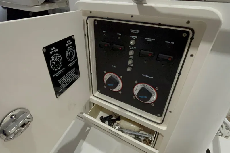 Slide: The Image of Control panel of a 2005 Boston Whaler 305 Conquest boat, showing battery switches. - 12