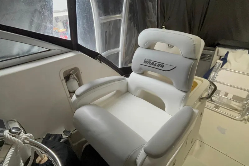 Slide: The Image of Captain's chair on 2005 Boston Whaler 305 Conquest boat, featuring sleek design and comfort. - 13