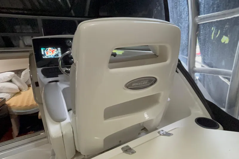 Slide: The Image of 2005 Boston Whaler 305 Conquest helm with navigation display and cushioned seating. - 14