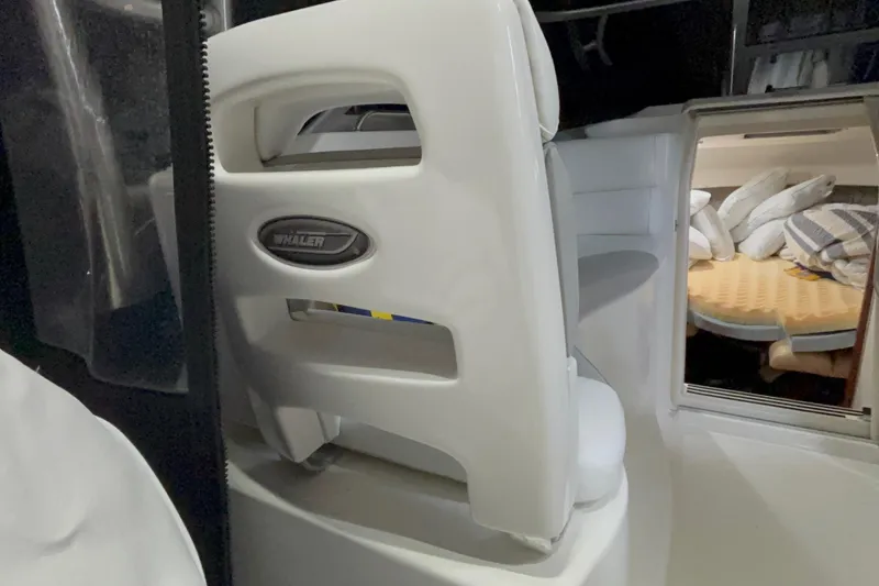 Slide: The Image of Interior of a 2005 Boston Whaler 305 Conquest boat, featuring seating and cabin area. - 15