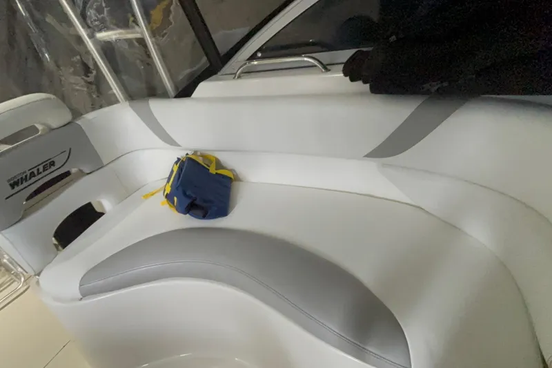 Slide: The Image of Interior seating of a 2005 Boston Whaler 305 Conquest boat with a small bag. - 18