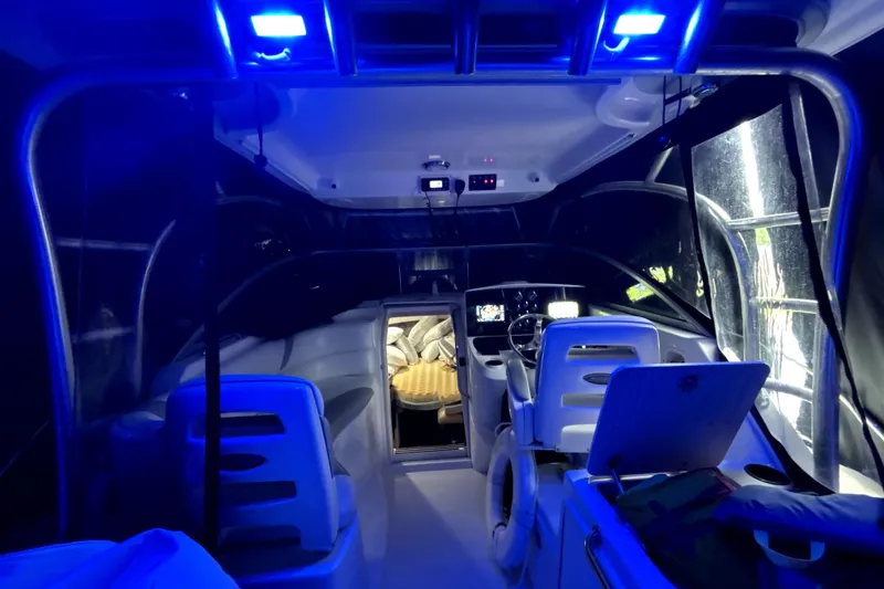 Slide: The Image of Interior of a 2005 Boston Whaler 305 Conquest boat with blue ambient lighting. - 20