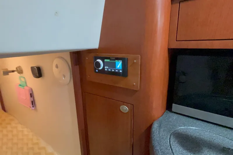 Slide: The Image of Interior of 2005 Boston Whaler 305 Conquest with control panel and wooden cabinetry. - 22
