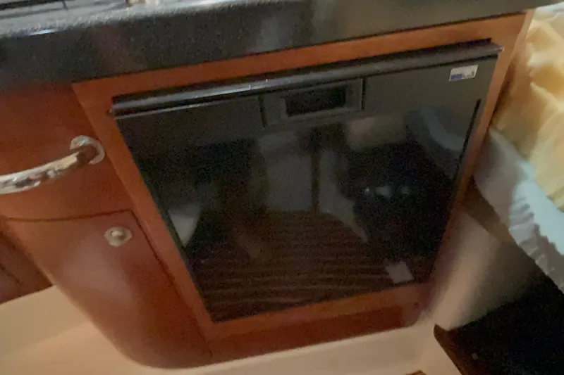 Slide: The Image of Compact refrigerator in 2005 Boston Whaler 305 Conquest boat interior. - 23