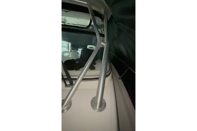 Slide: The Image of 2005 Boston Whaler 305 Conquest interior view with metal railings. - 25