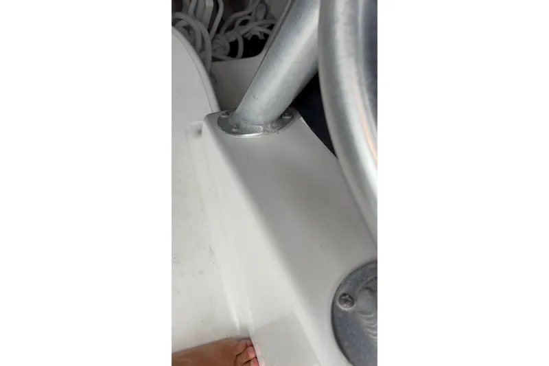Slide: The Image of Close-up of 2005 Boston Whaler 305 Conquest boat interior, showing metal fixtures and white surface. - 30