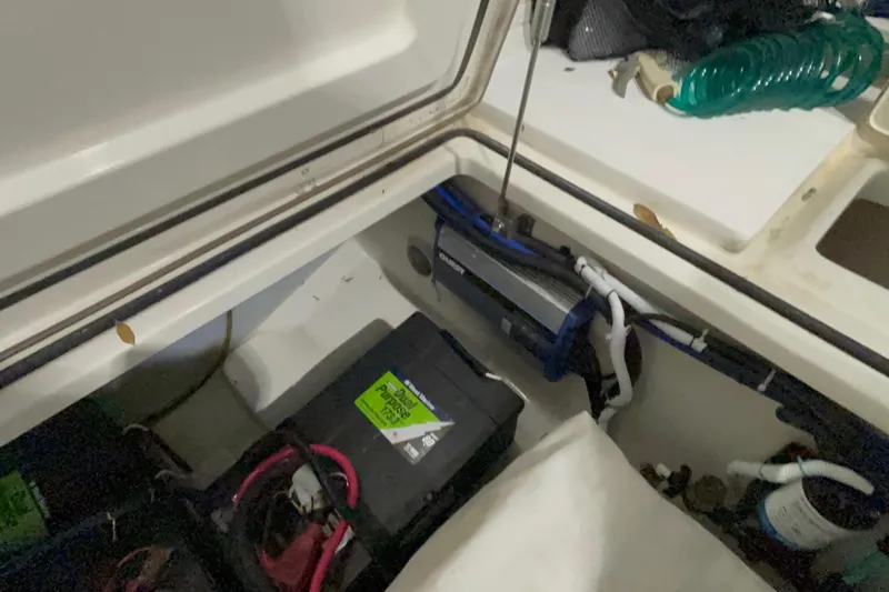 Slide: The Image of 2005 Boston Whaler 305 Conquest battery compartment with wiring and equipment. - 43