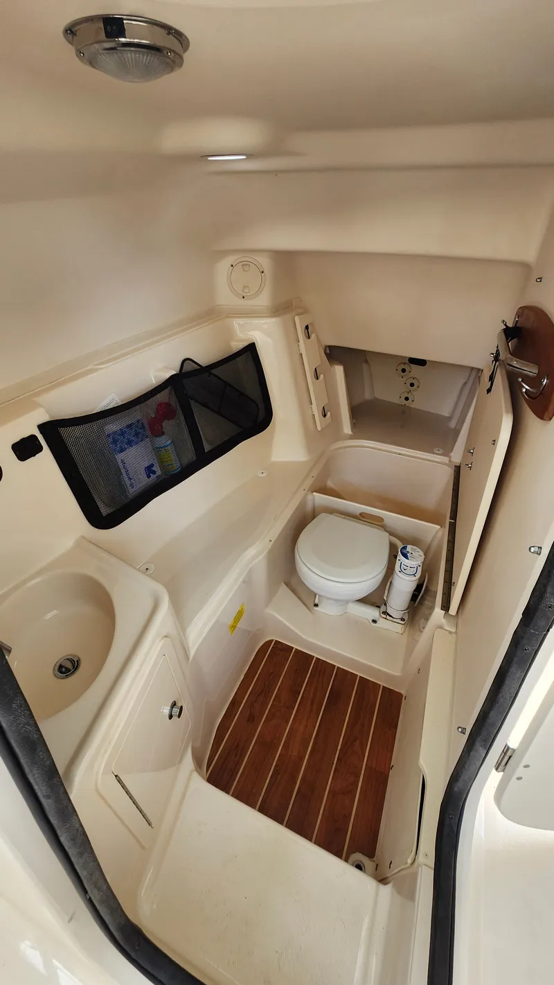 Slide: The Image of Interior of 2019 Grady-White Freedom 307 with toilet and sink. - 14