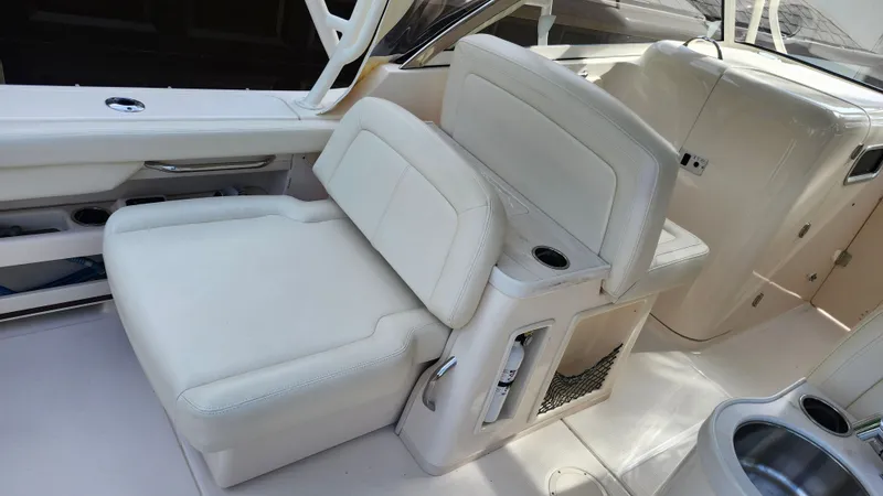 Slide: The Image of Interior of a 2019 Grady-White Freedom 307 boat with beige seating area. - 5