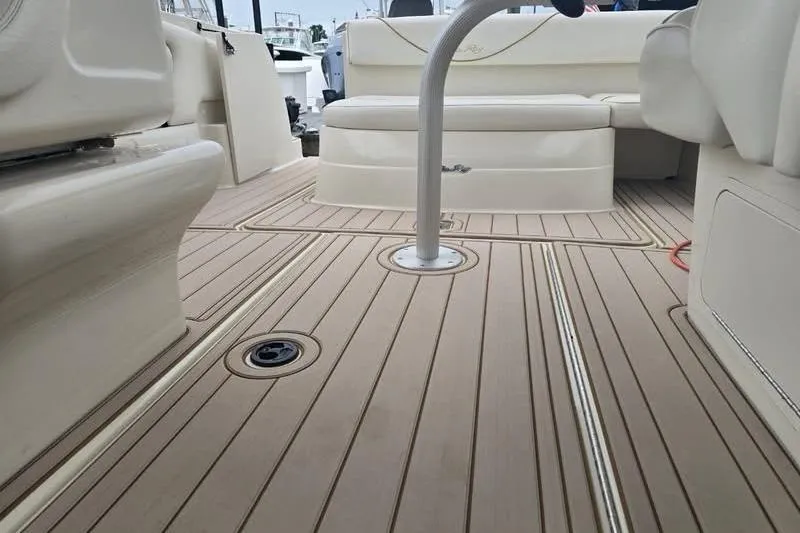 Slide: The Image of Interior view of 2001 Sea Ray 245 Weekender boat with beige seating and deck. - 4