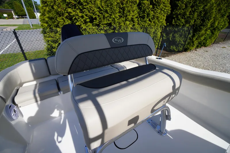 Slide: The Image of 2025 Key West 203 FS boat interior with beige seating and stainless steel fixtures. - 16