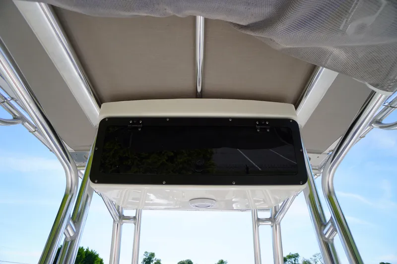 Slide: The Image of 2025 Key West 203 FS boat console with overhead storage and canopy, viewed from below. - 17
