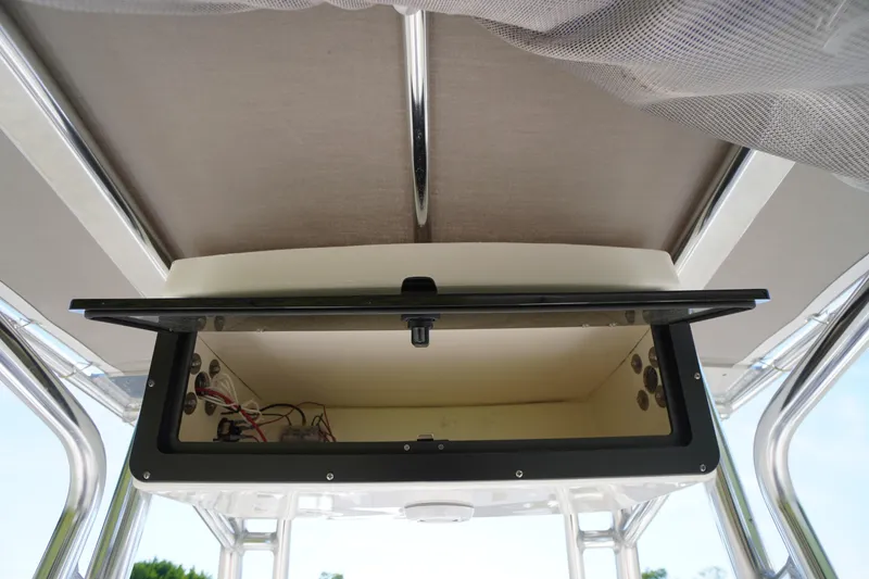 Slide: The Image of Open storage compartment on 2025 Key West 203 FS boat, showcasing interior wiring. - 18