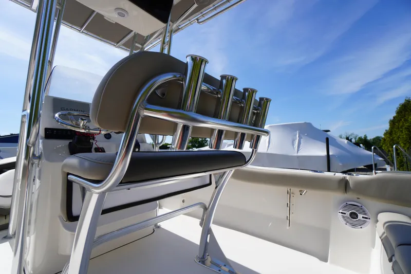 Slide: The Image of 2025 Key West 203 FS boat interior with rod holders and seating under clear blue sky. - 19
