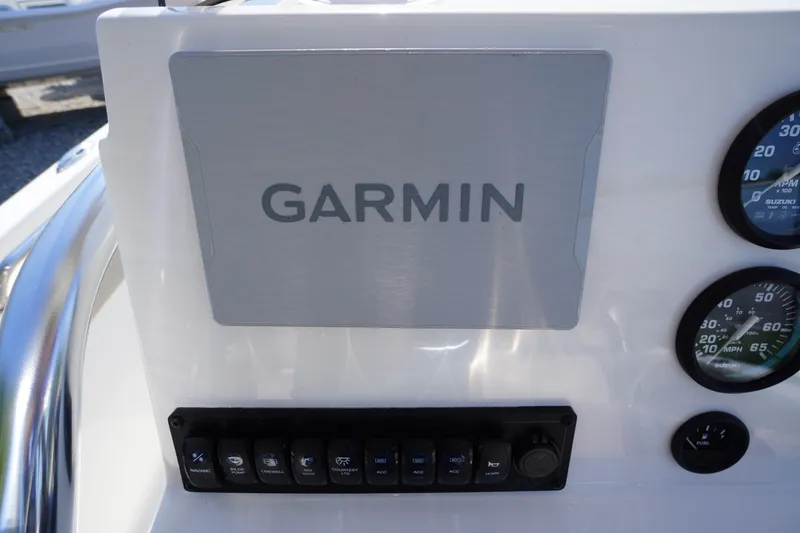 Slide: The Image of Garmin navigation system on 2025 Key West 203 FS boat dashboard with gauges. - 21