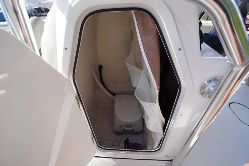 Slide: The Image of 2025 Key West 203 FS boat interior with compact marine toilet. - 25