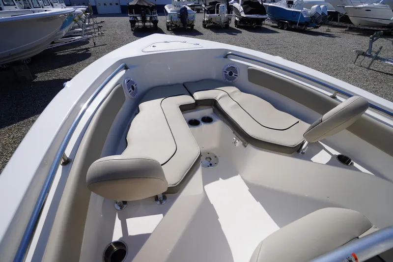 Slide: The Image of 2025 Key West 203 FS boat interior with cushioned seating and cup holders. - 29