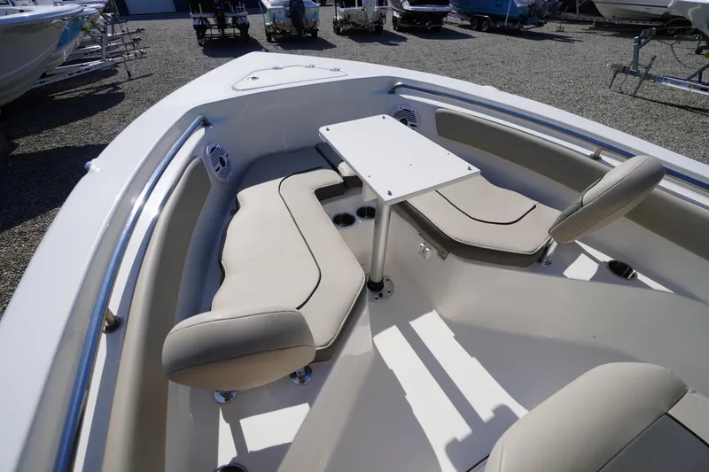 Slide: The Image of 2025 Key West 203 FS boat interior with seating and table, displayed outdoors. - 30