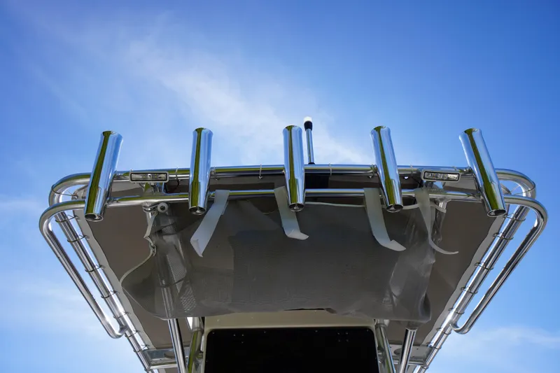 Slide: The Image of 2025 Key West 203 FS boat with rod holders against a clear blue sky. - 40
