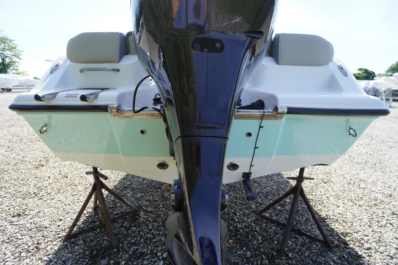 Slide: The Image of Rear view of 2025 Key West 203 FS boat on stands, showcasing engine and hull. - 5