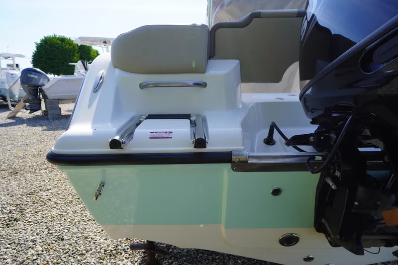 Slide: The Image of 2025 Key West 203 FS boat stern with ladder and outboard motor. - 6