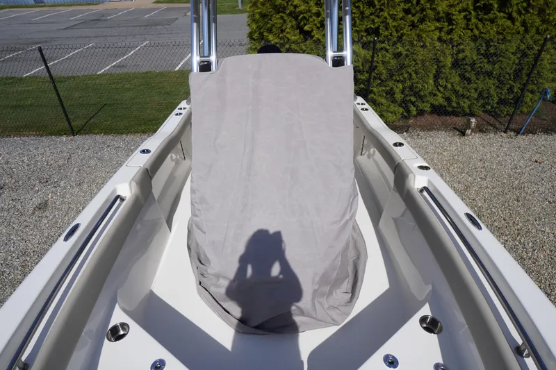 Slide: The Image of 2025 Key West 203 FS boat interior with covered console, parked outdoors. - 8
