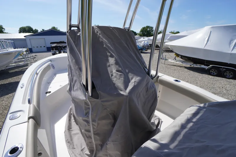 Slide: The Image of 2025 Key West 203 FS boat with protective cover in a marina setting. - 9