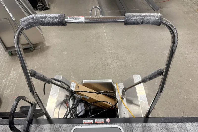 Slide: The Image of 2026 Bennington 22 S Quad Bench boat ladder with protective wrapping in a workshop setting. - 15