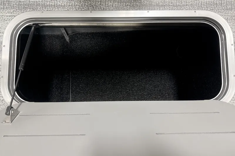 Slide: The Image of Open storage compartment in 2026 Bennington 22 S Quad Bench boat. - 16