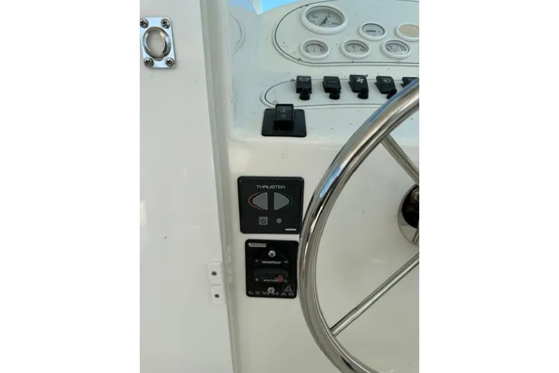 Slide: The Image of 2006 Baha Cruisers 300 GLE helm with steering wheel and control panel. - 10