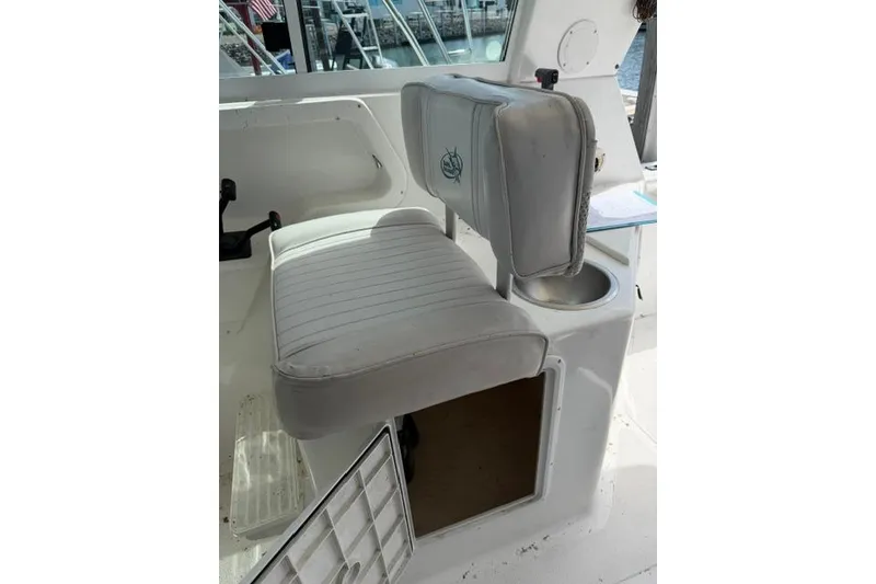 Slide: The Image of 2006 Baha Cruisers 300 GLE boat interior with white cushioned seating and storage compartment. - 14