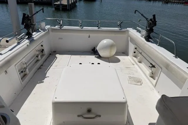 Slide: The Image of 2006 Baha Cruisers 300 GLE boat deck with fishing equipment, docked by the water. - 16