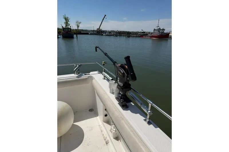 Slide: The Image of 2006 Baha Cruisers 300 GLE boat with fishing rod holder on calm waters. - 17