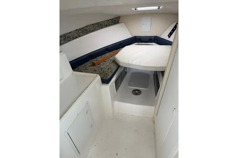 Slide: The Image of 2006 Baha Cruisers 300 GLE cabin interior with bed and storage compartments. - 4