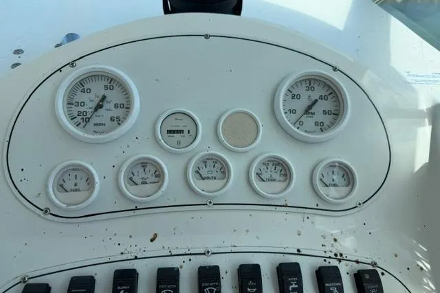 Slide: The Image of Dashboard of a 2006 Baha Cruisers 300 GLE boat with various gauges and controls. - 5