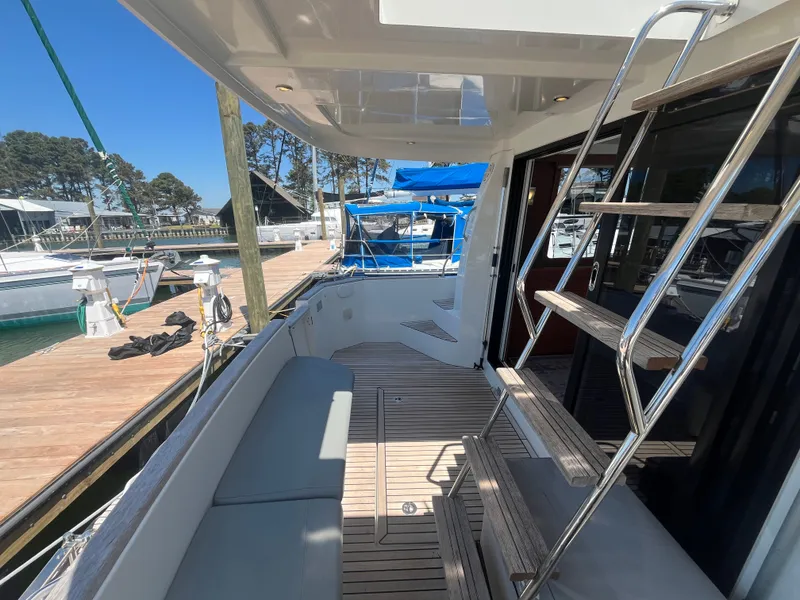 Slide: The Image of 2015 Beneteau Swift Trawler 34 Fly, deck view with seating and stairs. - 2