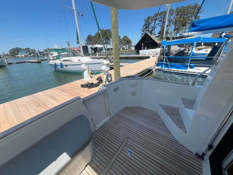 Slide: The Image of Beneteau Swift Trawler 34 Fly 2015 at dock with sailboats. - 3
