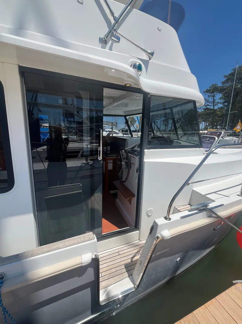 Slide: The Image of 2015 Beneteau Swift Trawler 34 Fly with open entrance and helm station. - 33