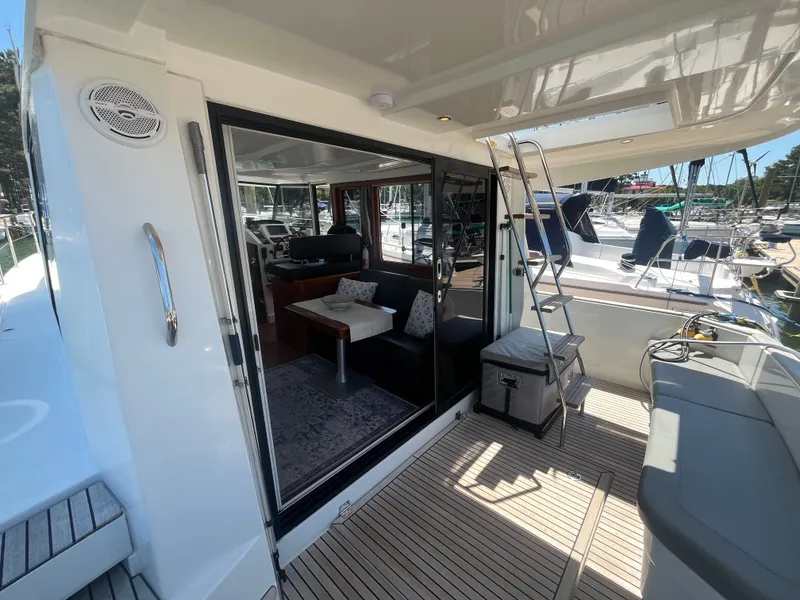 Slide: The Image of 2015 Beneteau Swift Trawler 34 Fly interior with seating area and ladder. - 4