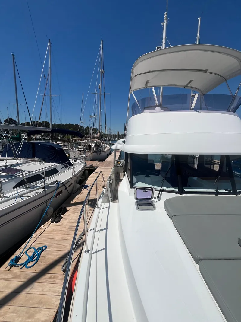Slide: The Image of 2015 Beneteau Swift Trawler 34 Fly docked at marina. - 35