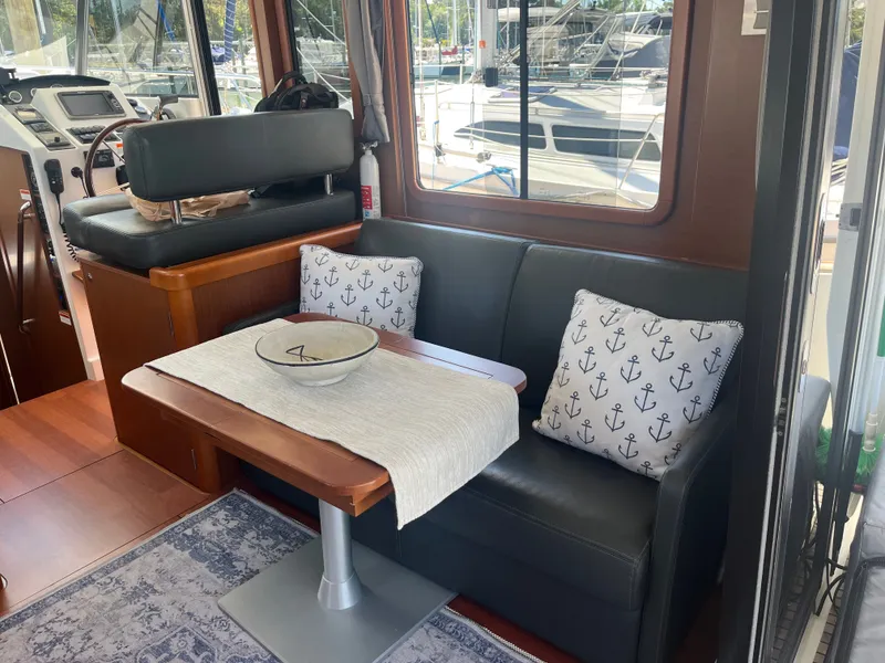Slide: The Image of Interior of 2015 Beneteau Swift Trawler 34 Fly with cozy seating area. - 7
