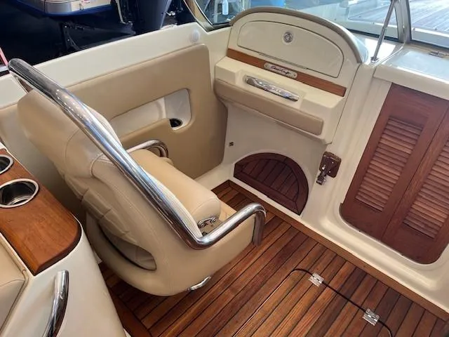 Slide: The Image of 2014 Chris-Craft Corsair 25 interior with leather seating and wooden accents. - 12